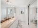 Bright bathroom with modern fixtures, marble countertops, and a large mirror reflecting the spacious interior at 17404 1St E St, Redington Shores, FL 33708