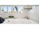 Relaxing bathroom featuring a large soaking tub with jets, a tiled backsplash and multiple fragrances at 17404 1St E St, Redington Shores, FL 33708
