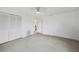 Bright bedroom featuring a ceiling fan, light laminate floors, and a spacious closet at 17404 1St E St, Redington Shores, FL 33708