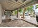 Covered patio with tile floor, bench, and view of tropical landscaping and the canal at 17404 1St E St, Redington Shores, FL 33708