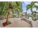 A beautiful backyard and dock with lush landscaping that overlooks the waterfront and boat lift at 17404 1St E St, Redington Shores, FL 33708