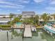 Waterfront home featuring a private pool, dock, and boat lift, perfect for luxurious coastal living and enjoying water activities at 17404 1St E St, Redington Shores, FL 33708