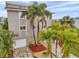 Beautiful exterior view of a multi-story home with a garage, complemented by palm trees and landscaped grounds at 17404 1St E St, Redington Shores, FL 33708