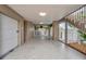 Garage and covered parking area featuring a finished floor, staircase, and gated access to the pool at 17404 1St E St, Redington Shores, FL 33708