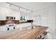 Modern kitchen featuring white cabinets, stainless steel appliances, and a marble countertop island at 17404 1St E St, Redington Shores, FL 33708