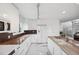 Bright modern kitchen with white cabinets and stainless appliances plus marble countertops and backsplash at 17404 1St E St, Redington Shores, FL 33708