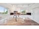 Bright kitchen with white cabinets, stylish backsplash, and a large center island with sink and marble countertop at 17404 1St E St, Redington Shores, FL 33708