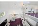 Bright, open floor plan featuring a modern spiral staircase and chic decor, with purple carpet at 17404 1St E St, Redington Shores, FL 33708