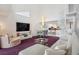 Open concept living room with high ceilings, spiral staircase, and modern furnishings, perfect for entertaining and relaxation at 17404 1St E St, Redington Shores, FL 33708
