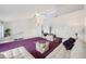 Living area features high vaulted ceilings, a ceiling fan, large windows, and purple carpeting at 17404 1St E St, Redington Shores, FL 33708