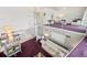 Bright, open floor plan featuring a modern spiral staircase and chic decor, with purple carpet at 17404 1St E St, Redington Shores, FL 33708