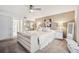Bright main bedroom with large dresser, king bed, ceiling fan and ensuite bathroom access at 17404 1St E St, Redington Shores, FL 33708