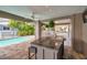 The outdoor bar features marble countertops, sink, seating, and a view of the inviting swimming pool at 17404 1St E St, Redington Shores, FL 33708