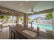 Luxury outdoor kitchen with marble countertop, a sink, and a view of the inviting swimming pool at 17404 1St E St, Redington Shores, FL 33708