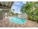 Private outdoor pool surrounded by brick pavers and tropical landscaping for a relaxing oasis at 17404 1St E St, Redington Shores, FL 33708
