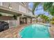 An outdoor swimming pool offers a space for relaxation and entertainment with tropical landscaping at 17404 1St E St, Redington Shores, FL 33708