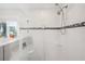 Elegant walk-in shower with a glass enclosure and dual shower heads, and stylish tile accents at 17404 1St E St, Redington Shores, FL 33708