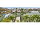Waterfront property with lush greenery, dock, and boatlift offering direct access to the water at 17404 1St E St, Redington Shores, FL 33708
