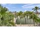 Scenic waterfront view highlighting lush palm trees along the canal, with boat dock at 17404 1St E St, Redington Shores, FL 33708