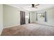 Bedroom with neutral walls, a ceiling fan, carpeted flooring, and windows with curtains at 1751 8Th Sw Ave, Largo, FL 33770