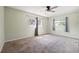 Bedroom with neutral walls, carpeted flooring, and windows with curtains and sunlight coming through at 1751 8Th Sw Ave, Largo, FL 33770