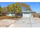 Charming light blue home with a garage and a palm tree in the front yard at 1751 8Th Sw Ave, Largo, FL 33770