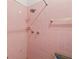 Pink tiled shower with shower head and temperature handles, white soap dish, towel rack and toilet at 1751 8Th Sw Ave, Largo, FL 33770