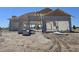 An exterior framing view of a home under construction, featuring concrete blocks and a wooden roof structure at 17976 Foxtail Loop, Venice, FL 34293