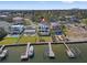 Waterfront home aerial view showcasing private docks, boats, manicured lawn, and waterfront access at 1843 Bayou Grande Ne Blvd, St Petersburg, FL 33703