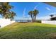 Large grassy backyard featuring a swing set and picturesque waterfront views at 1843 Bayou Grande Ne Blvd, St Petersburg, FL 33703