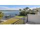 Waterfront backyard featuring a boat dock and lift, grassy area and landscaping seen from an upper deck at 1843 Bayou Grande Ne Blvd, St Petersburg, FL 33703