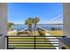 Waterfront backyard featuring a dock, boat lift, fenced yard, and tropical landscaping at 1843 Bayou Grande Ne Blvd, St Petersburg, FL 33703
