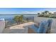 Relaxing balcony with comfortable chairs, offering a picturesque view of the water and nearby dock at 1843 Bayou Grande Ne Blvd, St Petersburg, FL 33703