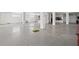 Unfinished basement space with gray epoxy floor, white walls, and minimal natural light at 1843 Bayou Grande Ne Blvd, St Petersburg, FL 33703