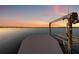 Private dock and boat lift offering direct access to the water with a picturesque sunset backdrop at 1843 Bayou Grande Ne Blvd, St Petersburg, FL 33703