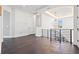 Hallway with dark wood floors, modern lighting fixture and railings at 1843 Bayou Grande Ne Blvd, St Petersburg, FL 33703