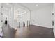 Hallway featuring dark hardwood floors, modern metal railings, and a striking geometric chandelier at 1843 Bayou Grande Ne Blvd, St Petersburg, FL 33703