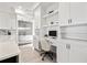 Bright kitchen with stainless steel refrigerator and a convenient adjacent built-in desk area with shelving at 1843 Bayou Grande Ne Blvd, St Petersburg, FL 33703