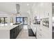 Modern kitchen featuring a large island, range, custom cabinets, and water views at 1843 Bayou Grande Ne Blvd, St Petersburg, FL 33703