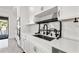 Modern kitchen featuring white cabinets, stainless steel appliances, and quartz countertops with black hardware at 1843 Bayou Grande Ne Blvd, St Petersburg, FL 33703