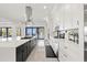 Bright kitchen featuring white cabinets, a large island, and views of the outdoors at 1843 Bayou Grande Ne Blvd, St Petersburg, FL 33703