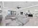 Spacious open-concept living room with large sectional sofa and a waterfront view at 1843 Bayou Grande Ne Blvd, St Petersburg, FL 33703