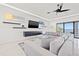 Contemporary living room with a large sectional, sleek entertainment center, and water view at 1843 Bayou Grande Ne Blvd, St Petersburg, FL 33703