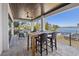 Outdoor dining area with waterfront views, ceiling fan, and modern flooring at 1843 Bayou Grande Ne Blvd, St Petersburg, FL 33703