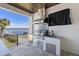 Outdoor kitchen area with a stainless steel grill, sink, and refrigerator with water views at 1843 Bayou Grande Ne Blvd, St Petersburg, FL 33703