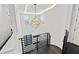 Staircase with dark hardwood floors, modern metal railings, and a striking geometric chandelier at 1843 Bayou Grande Ne Blvd, St Petersburg, FL 33703