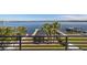 Scenic water view from a balcony overlooking a lush green lawn and a dock with boats at 1843 Bayou Grande Ne Blvd, St Petersburg, FL 33703