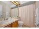 Bathroom featuring a vanity, mirror, and a combination shower and bathtub at 2446 Bentley Dr, Palm Harbor, FL 34684