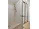 Bathroom shower featuring tile and showerhead, with a glass door to another room at 2446 Bentley Dr, Palm Harbor, FL 34684