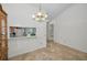 Open dining room features tile flooring and a breakfast bar view to the kitchen at 2446 Bentley Dr, Palm Harbor, FL 34684
